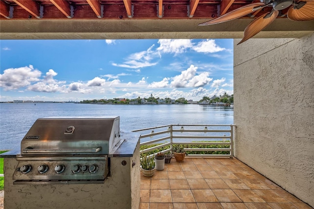 view of patio / terrace with ceiling fan, a grill, a water view, and a balcony