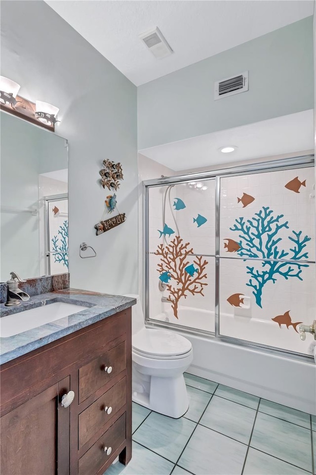 full bathroom with tile patterned flooring, vanity, toilet, and enclosed tub / shower combo