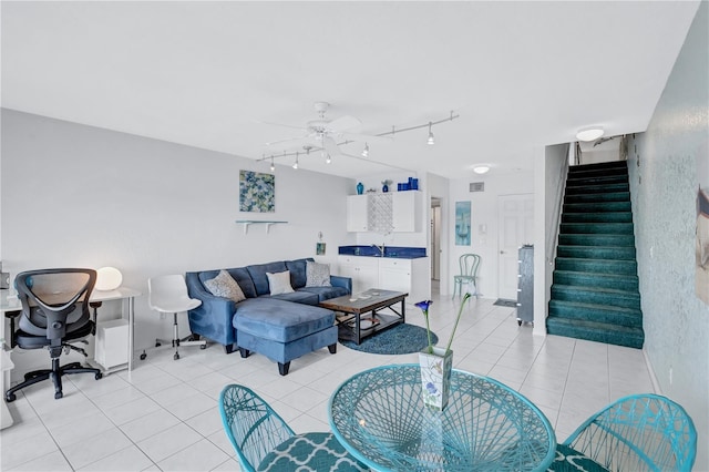 living room featuring ceiling fan and light tile patterned floors