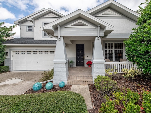4709 Corsage Dr, Lutz, FL 33558 - view of front of home featuring covered porch, driveway, brick siding, a garage, and stucco siding