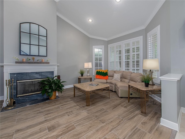 living room with a premium fireplace, crown molding, and vaulted ceiling