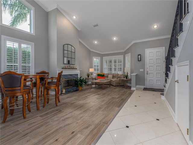 4709 Corsage Dr, Lutz, FL 33558 - living room featuring crown molding, a fireplace, stairs, recessed lighting, and light wood-type flooring