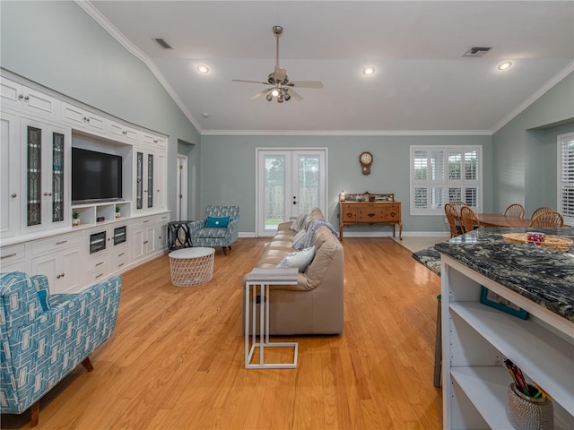 4709 Corsage Dr, Lutz, FL 33558 - living area featuring vaulted ceiling, light wood-style floors, ceiling fan, crown molding, and recessed lighting