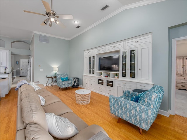 4709 Corsage Dr, Lutz, FL 33558 - living room with crown molding, light wood finished floors, ceiling fan, and lofted ceiling