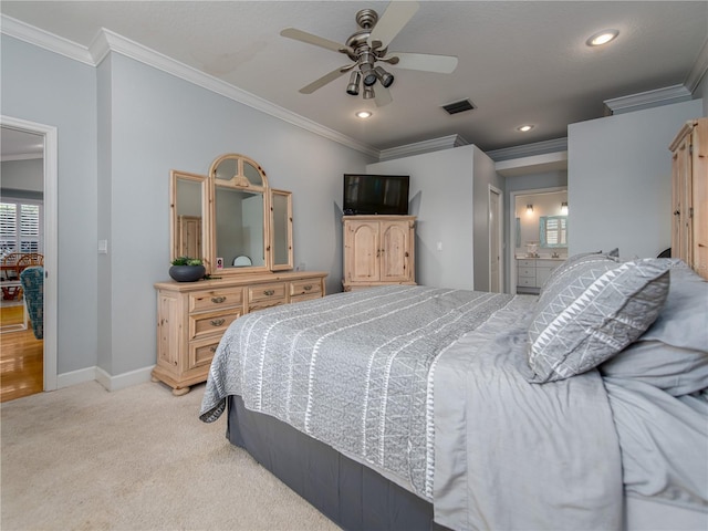 bedroom featuring light carpet, ensuite bath, ceiling fan, and crown molding