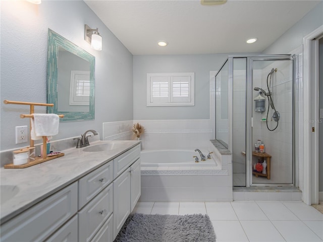 bathroom with tile patterned flooring, vanity, and plus walk in shower