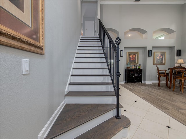 4709 Corsage Dr, Lutz, FL 33558 - stairs featuring ornamental molding and tile patterned flooring