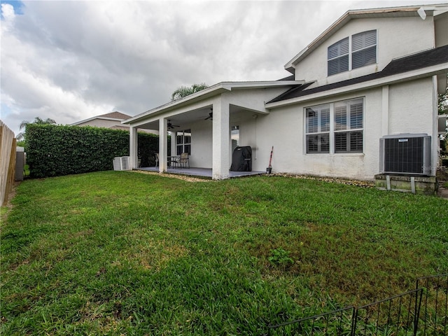 4709 Corsage Dr, Lutz, FL 33558 - rear view of property featuring stucco siding, ceiling fan, a patio, and a fenced backyard