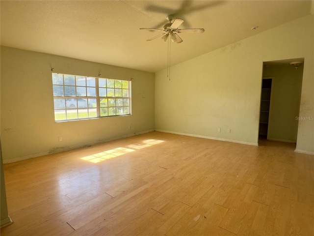 empty room featuring ceiling fan, light hardwood / wood-style floors, and vaulted ceiling