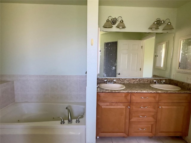 bathroom featuring a washtub, vanity, and tile patterned floors