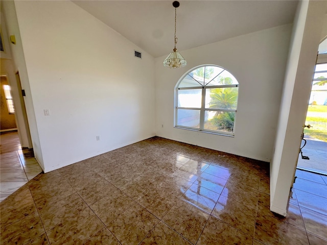 unfurnished dining area featuring a chandelier and vaulted ceiling