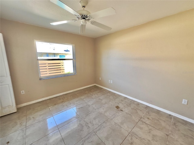 empty room featuring ceiling fan and light tile patterned floors