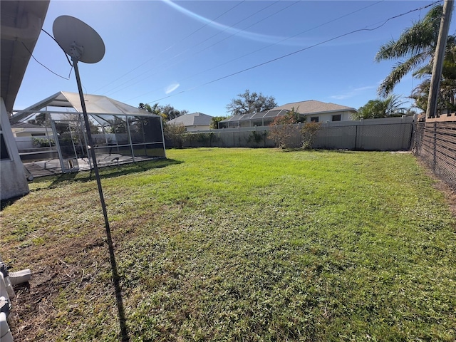 view of yard featuring glass enclosure