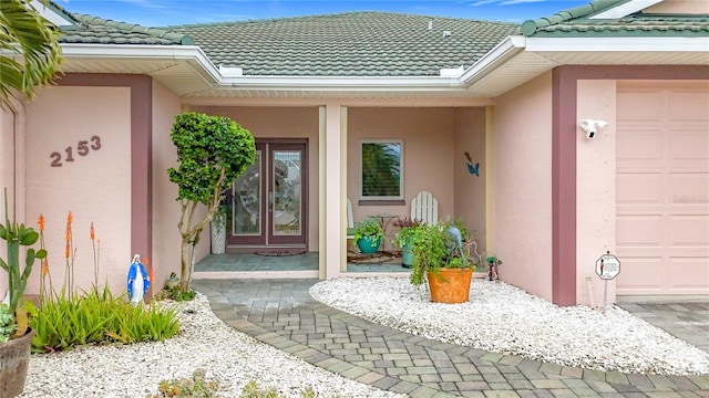 doorway to property with a garage