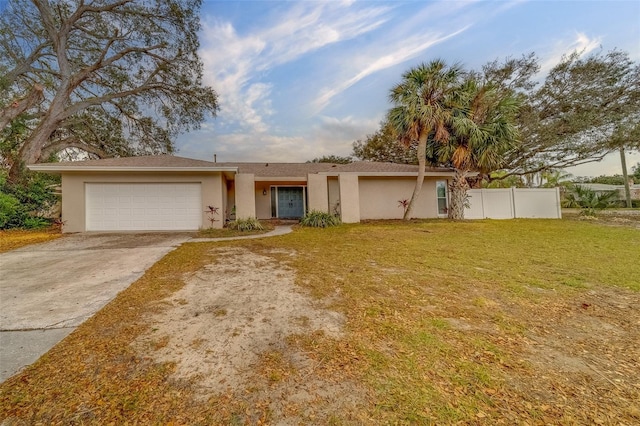 single story home featuring a garage and a front yard