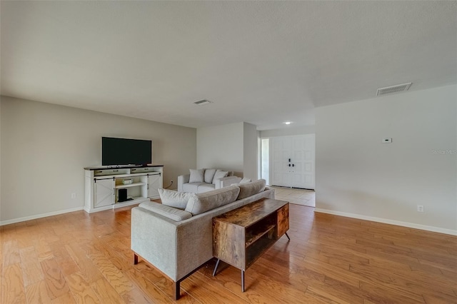 living room with light hardwood / wood-style flooring