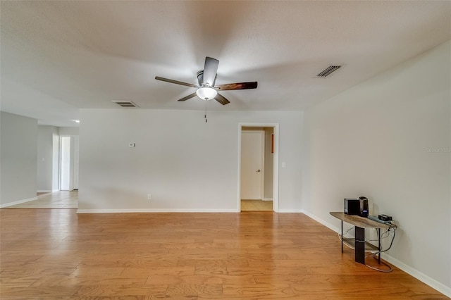 unfurnished room with ceiling fan, light hardwood / wood-style floors, and a textured ceiling