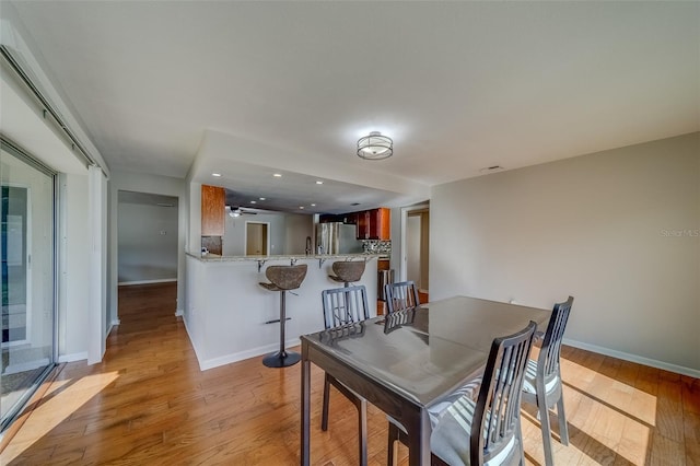 dining space with light hardwood / wood-style flooring