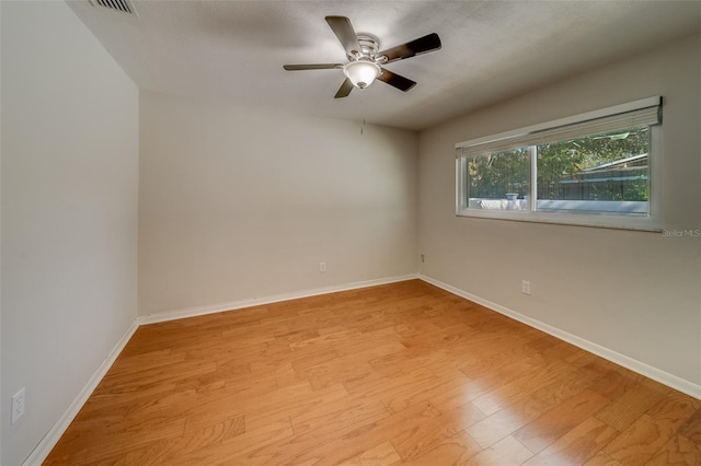 empty room featuring ceiling fan and light hardwood / wood-style floors