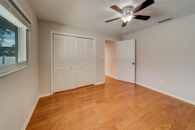 unfurnished bedroom with ceiling fan, a closet, and light hardwood / wood-style floors