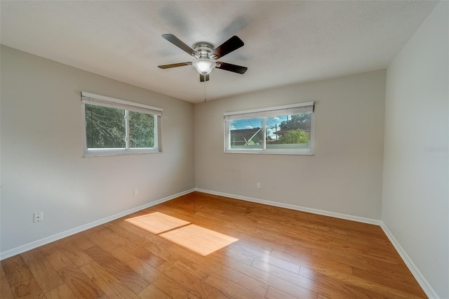 spare room featuring ceiling fan and light hardwood / wood-style flooring