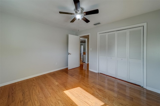 unfurnished bedroom with ceiling fan, a closet, and light hardwood / wood-style floors