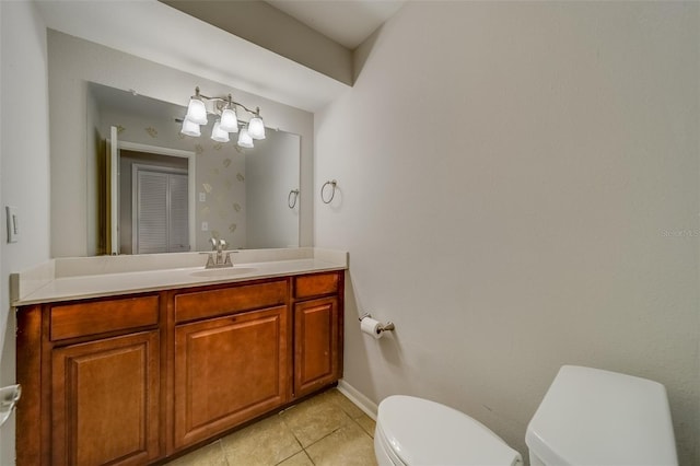 bathroom featuring tile patterned flooring, vanity, and toilet