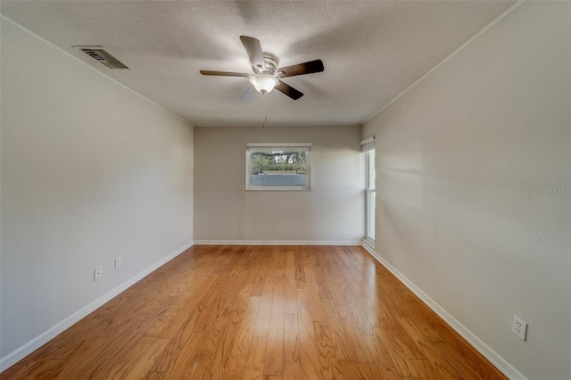 spare room featuring a textured ceiling, light hardwood / wood-style flooring, and ceiling fan