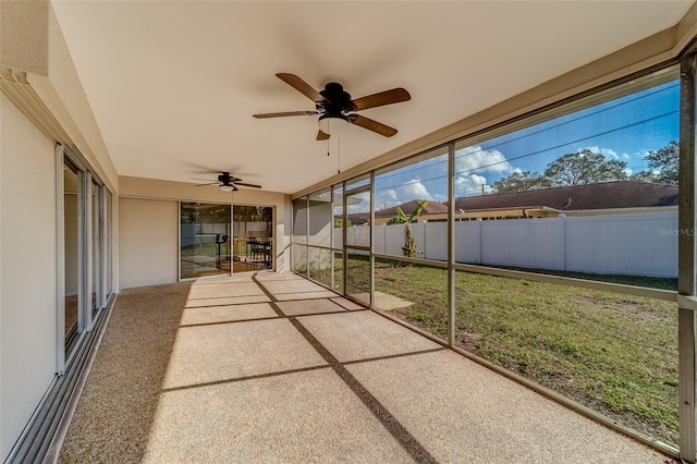 unfurnished sunroom featuring ceiling fan