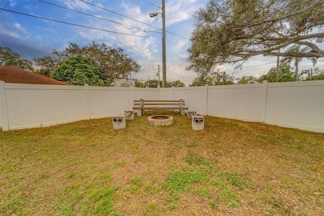 view of yard with an outdoor fire pit