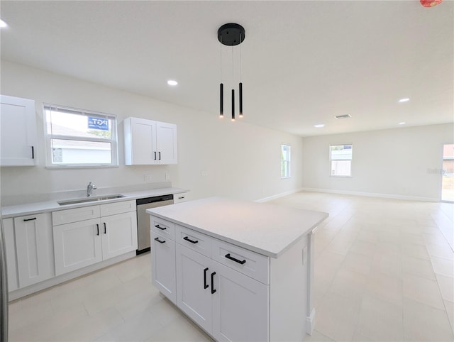 kitchen featuring a kitchen island, white cabinetry, sink, hanging light fixtures, and stainless steel dishwasher