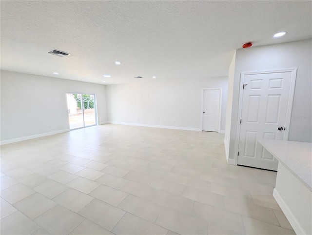 empty room with a textured ceiling