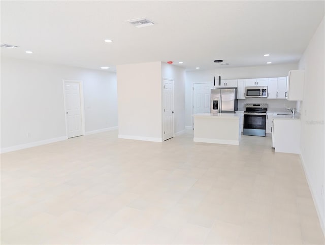 kitchen with white cabinetry, sink, hanging light fixtures, a center island, and stainless steel appliances