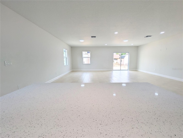 spare room with a textured ceiling