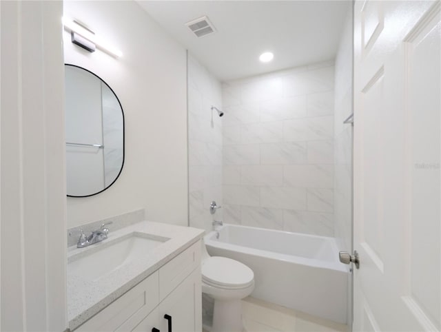 full bathroom featuring vanity, tiled shower / bath combo, and toilet