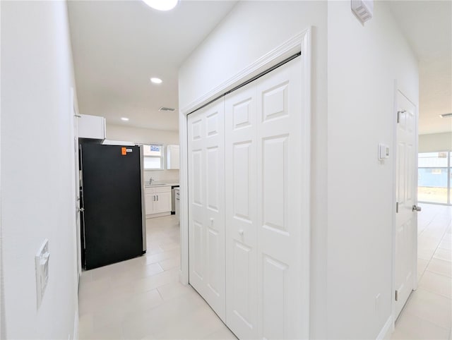 corridor with light tile patterned flooring