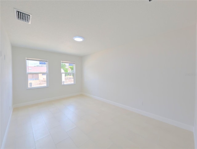 unfurnished room featuring a textured ceiling