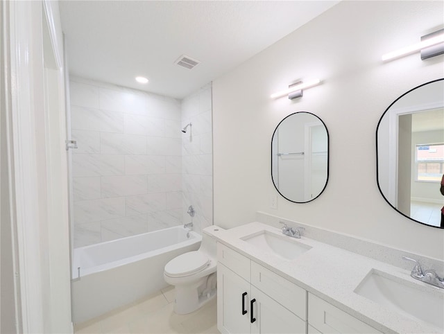 full bathroom featuring tiled shower / bath combo, vanity, and toilet