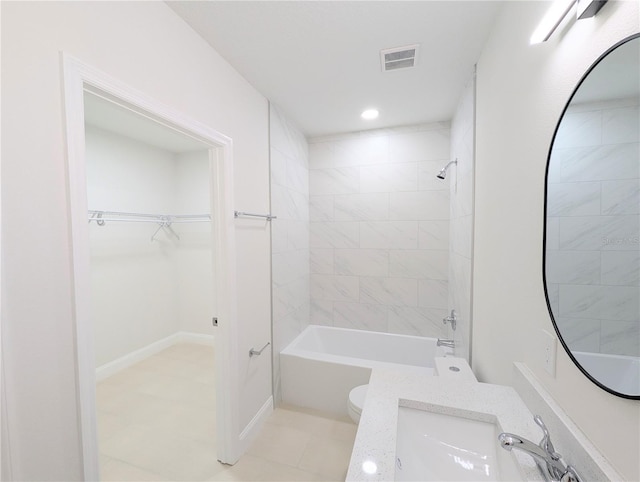 full bathroom with vanity, toilet, and tiled shower / bath combo