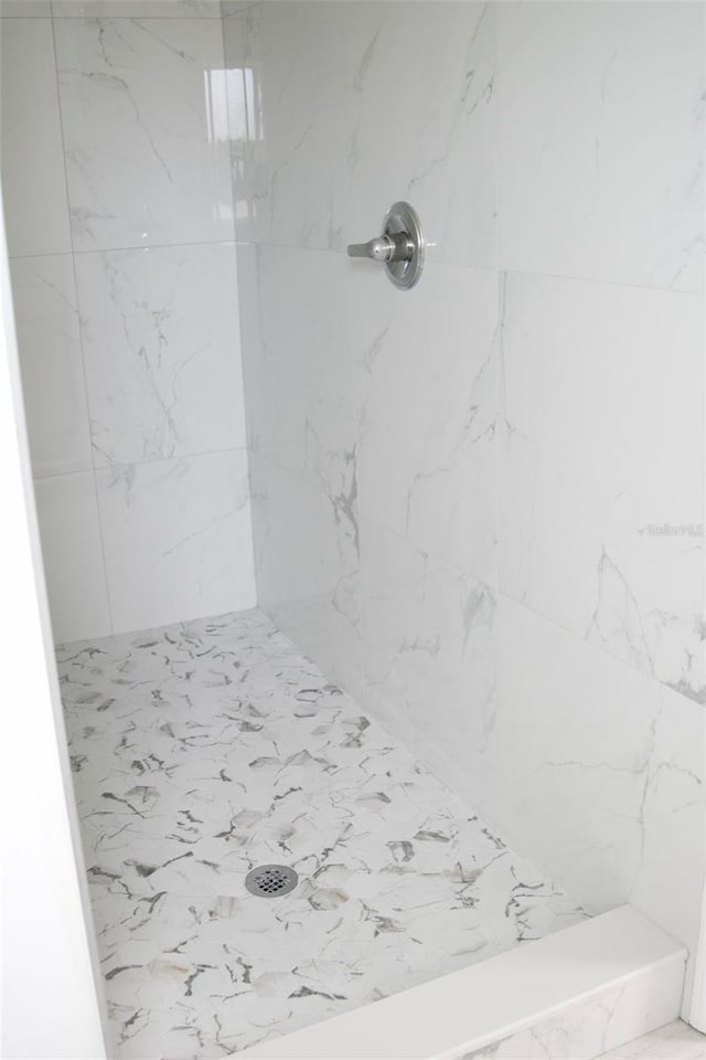 bathroom with a tile shower