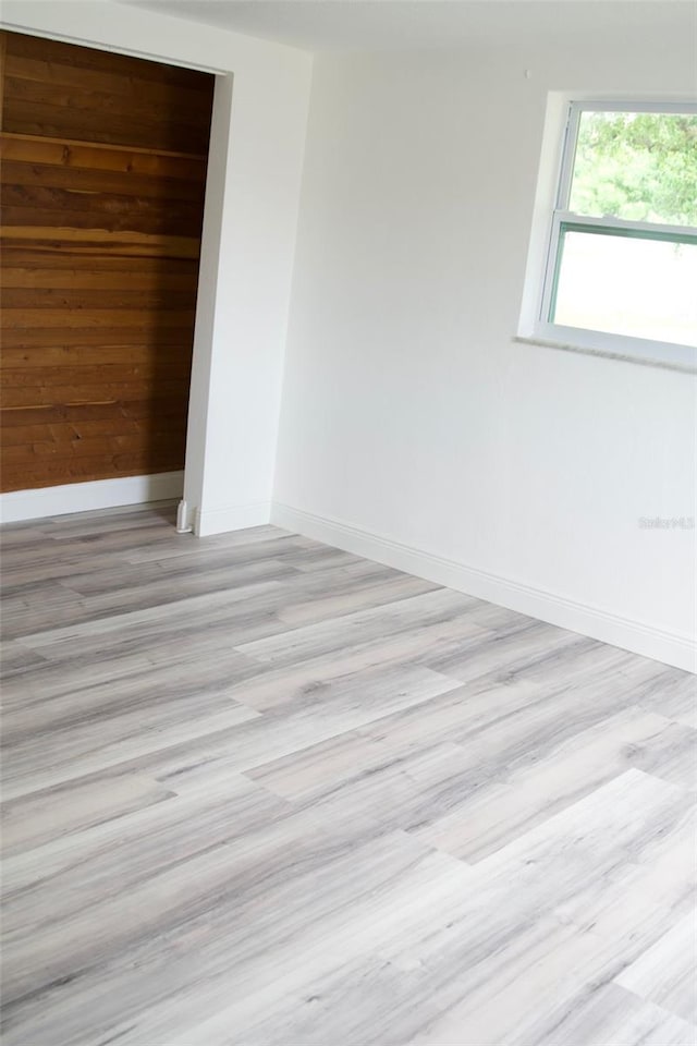 unfurnished room with light hardwood / wood-style floors