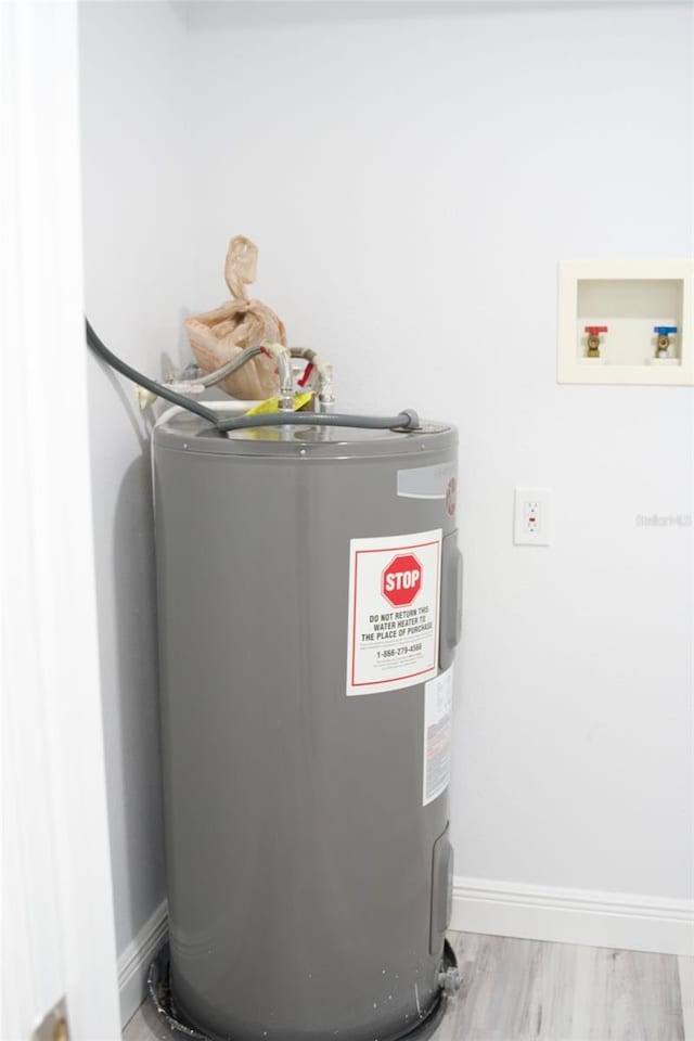 utility room featuring water heater