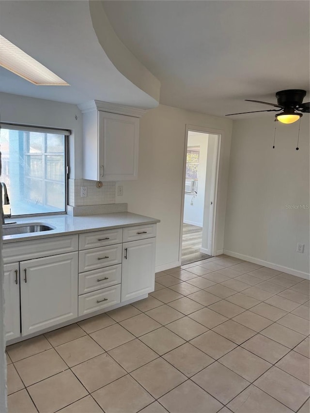 kitchen featuring white cabinets, light tile patterned floors, ceiling fan, and a healthy amount of sunlight