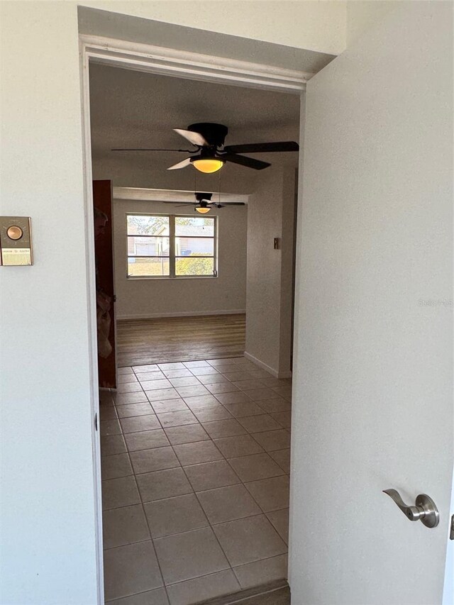 hallway featuring tile patterned flooring