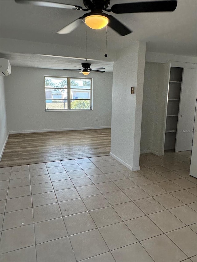 tiled spare room featuring a wall mounted air conditioner