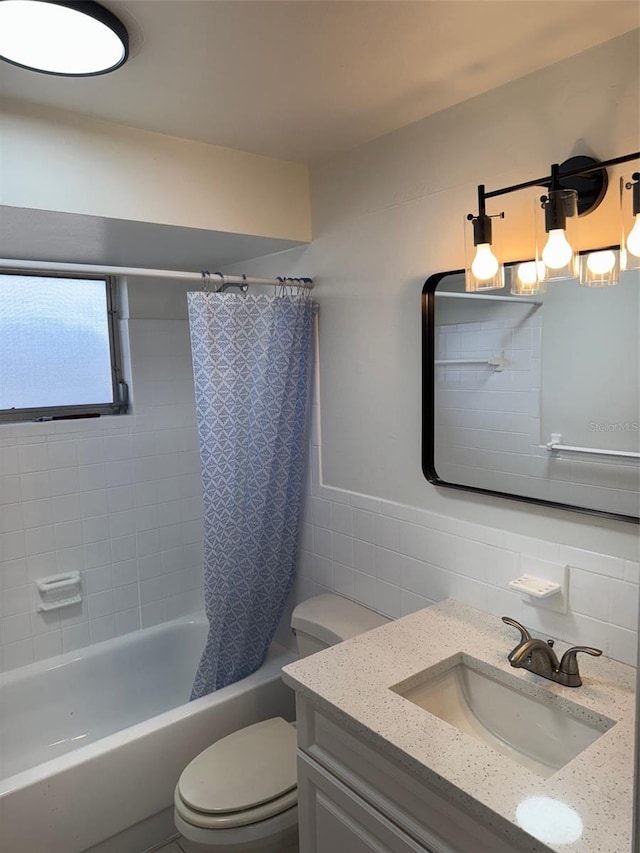 full bathroom featuring vanity, toilet, tile walls, and shower / tub combo with curtain