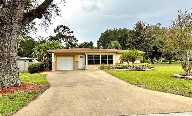 ranch-style home with a garage and a front yard