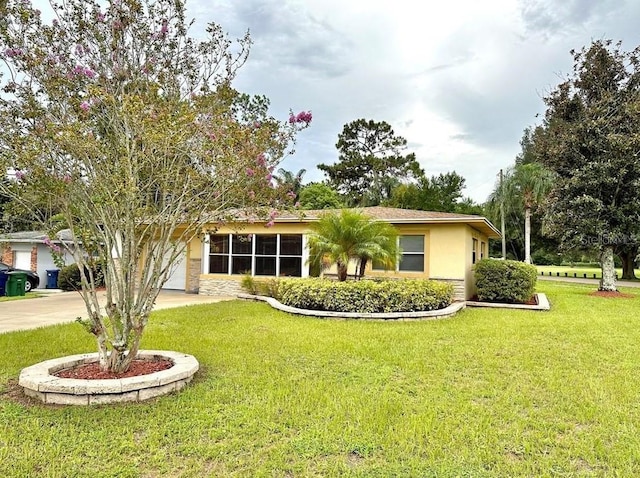 single story home featuring a garage and a front lawn