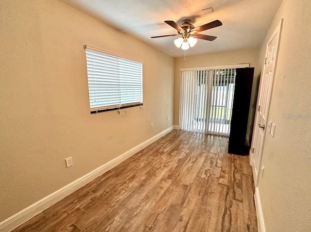 unfurnished room with ceiling fan, a healthy amount of sunlight, and light hardwood / wood-style flooring