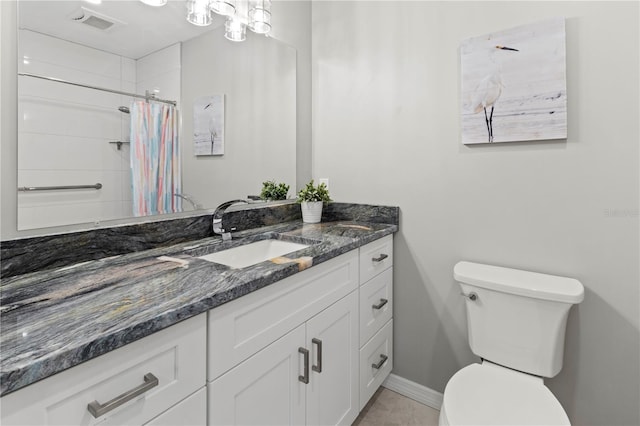 bathroom with vanity, toilet, and walk in shower